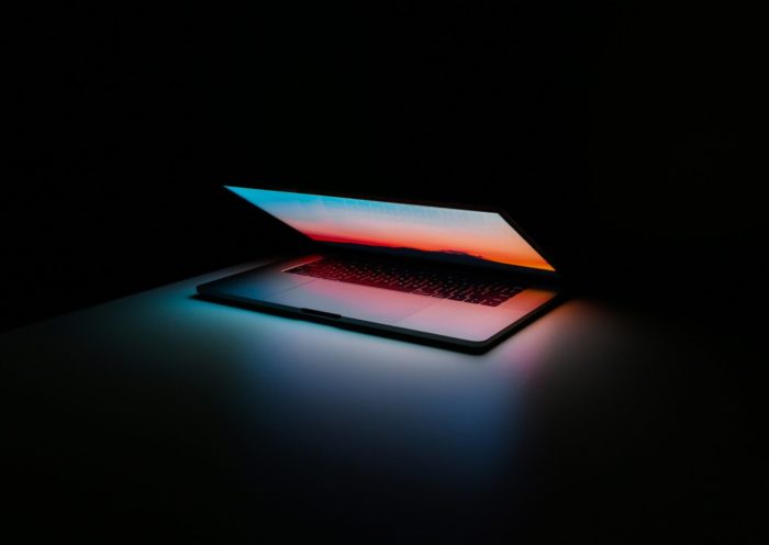 Open laptop computer with bright light from screen